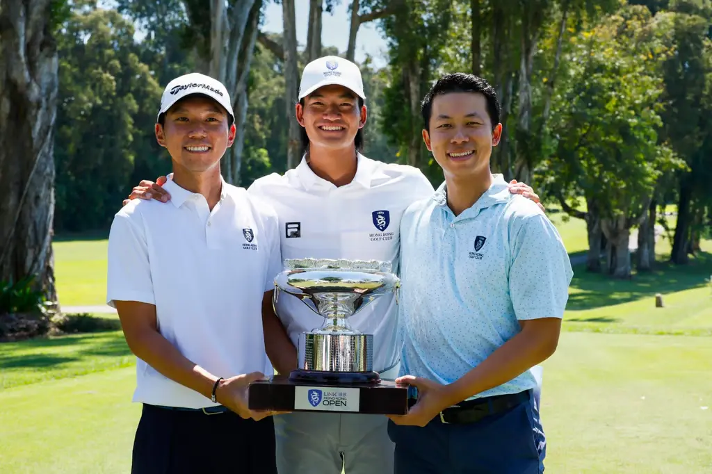 Terrence Ng (left) and Michael Regan Wong (right) with Taichi Kho and the trophy. Photo: Hong Kong Golf Club